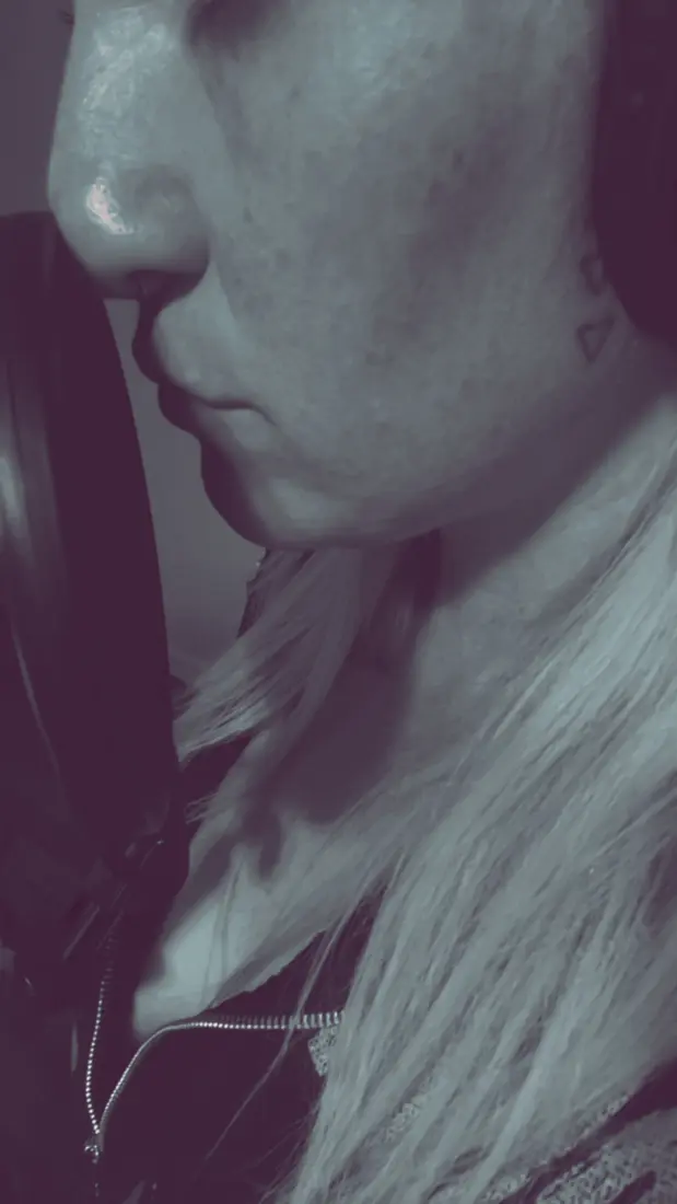 Close profile of Nikyla's nose and lips at the pop filter.